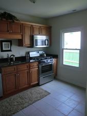 Remodeled Kitchen with new cabinets, appliances and tile floors by compton Contracting